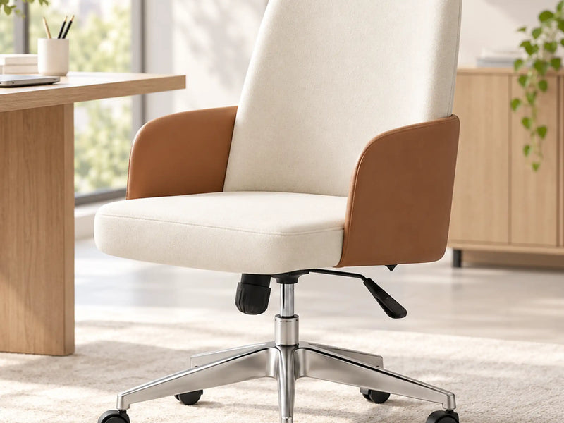 Cream upholstered office chair with brown armrests and a wheeled metal base beside a desk.