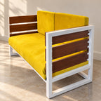 Cozy sofa with yellow cushions, white frame and dark slatted side panel