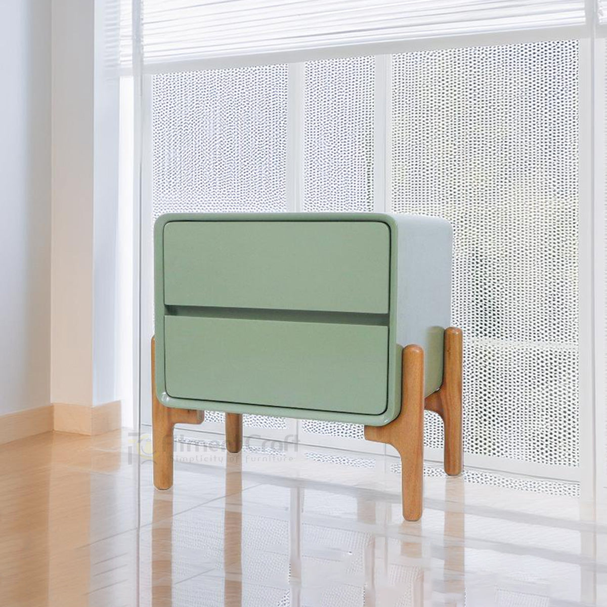 Rexa modern bedside table in sage green with two storage drawers and natural wood legs in a bright bedroom setting