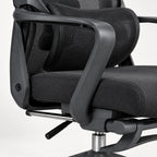 Close-up of a black mesh office chair with a padded seat and curved armrests on a light gray background.