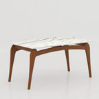 Aira dining table with a white veined top and brown curved legs, angled view