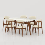 Aira dining table with a white veined top, shown with six cream upholstered chairs