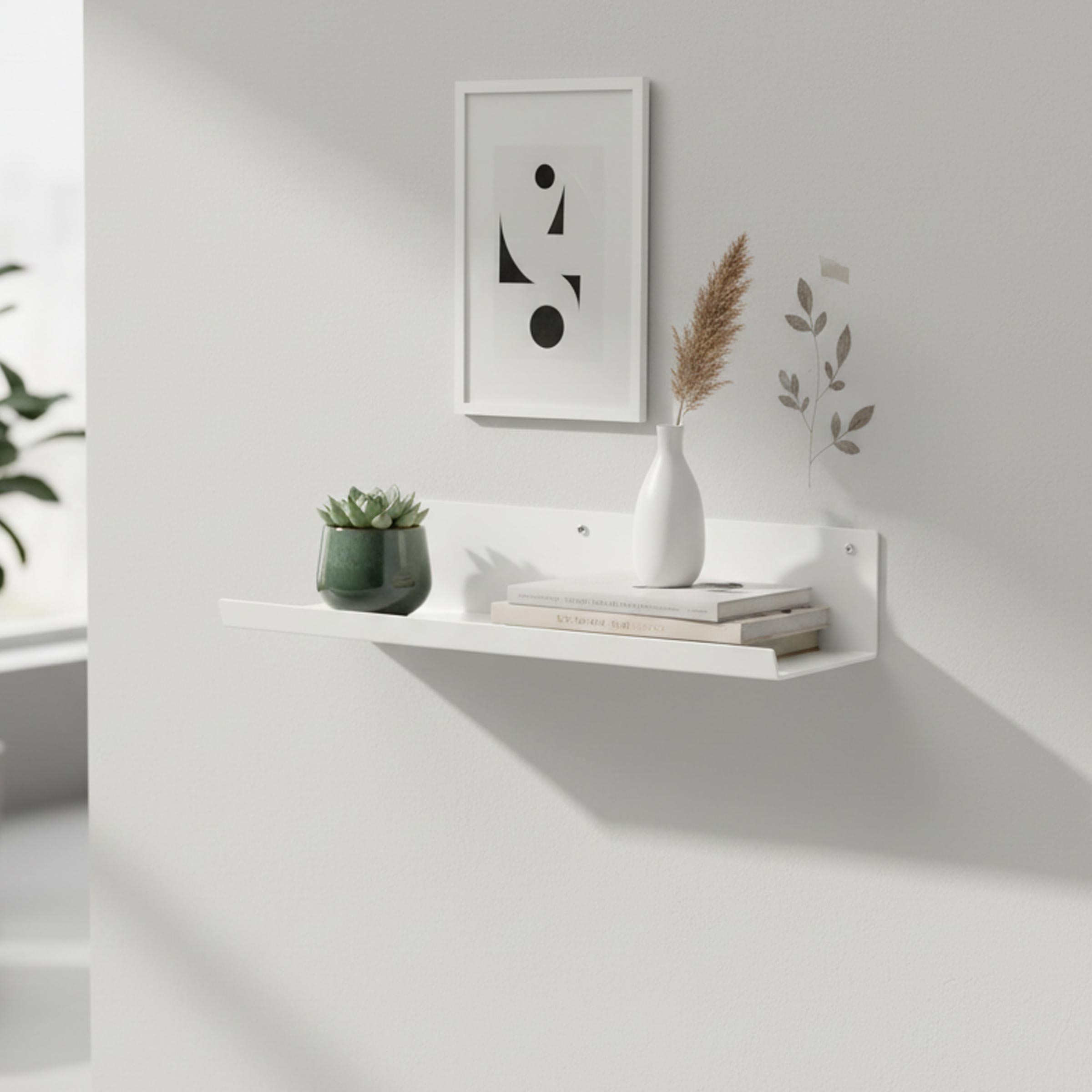 Minimalist white metal wall decor shelf, ideal for organizing books, plants, or decorative items in any modern space.