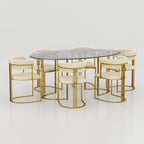 Luxury Halen dining table featuring transparent glass top and elegant golden metal structure.