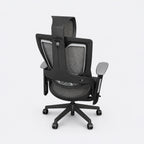 Rear view of Juhimin ergonomic office chair with black mesh backrest, adjustable headrest, armrests and five-star caster base.