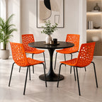 Four orange Lattice Outdoor Chairs around a black round dining table in a modern home, cafe or restaurant seating setup.