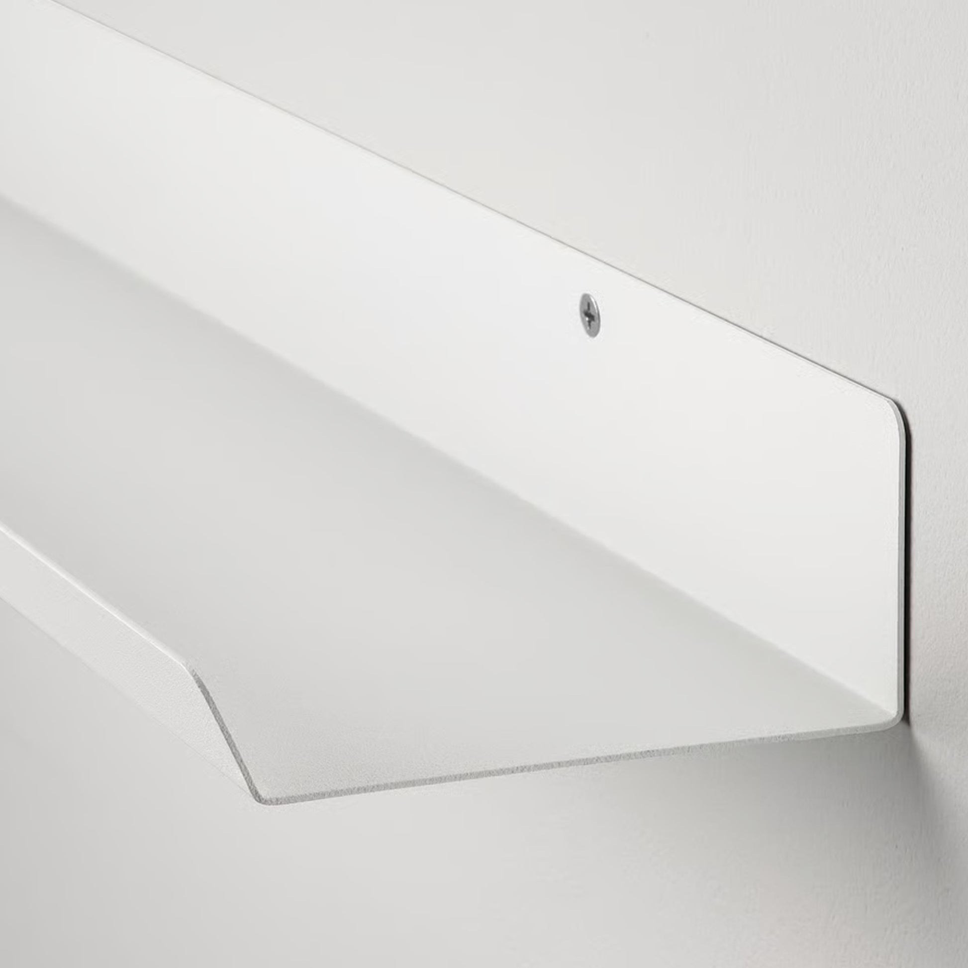 Malmback Display shelf holding picture frames on a modern white wall