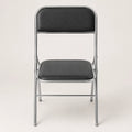 Shai Folding Chair with black padded seat and backrest, chrome metal frame and compact foldable design.