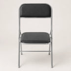 Shai Folding Chair with black padded seat and backrest, chrome metal frame and compact foldable design.