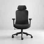 A modern black fabric office chair with a headrest, adjustable armrests, and a five-star wheeled base, shown against a neutral light gray background.
