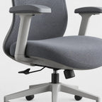 Close-up of a gray fabric office chair with a mesh back, light gray armrests, and a five-star base on a white background.