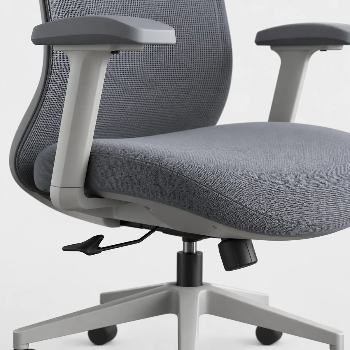 Close-up of a gray fabric office chair with a mesh back, light gray armrests, and a five-star base on a white background.