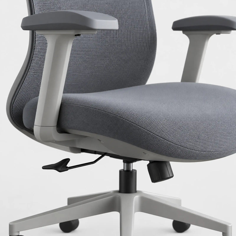 Close-up of a gray fabric office chair with a mesh back, light gray armrests, and a five-star base on a white background.