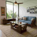 Arcube center table with glass top and curved brown base in a living room