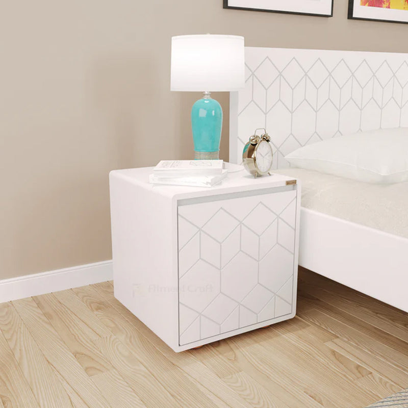 White Astro bedside cabinet with geometric door pattern and lamp beside a bed