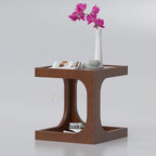 Brown Satin side table with curved supports, flowers and open magazine