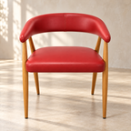 Red Contour café chair with wood-look frame and padded curved back, front view in a café corner