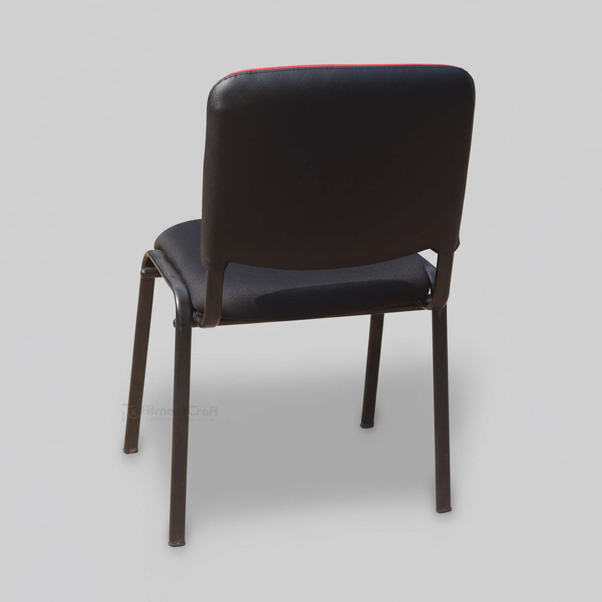 Crux visitor chair with dark padded back and seat, rear angled view