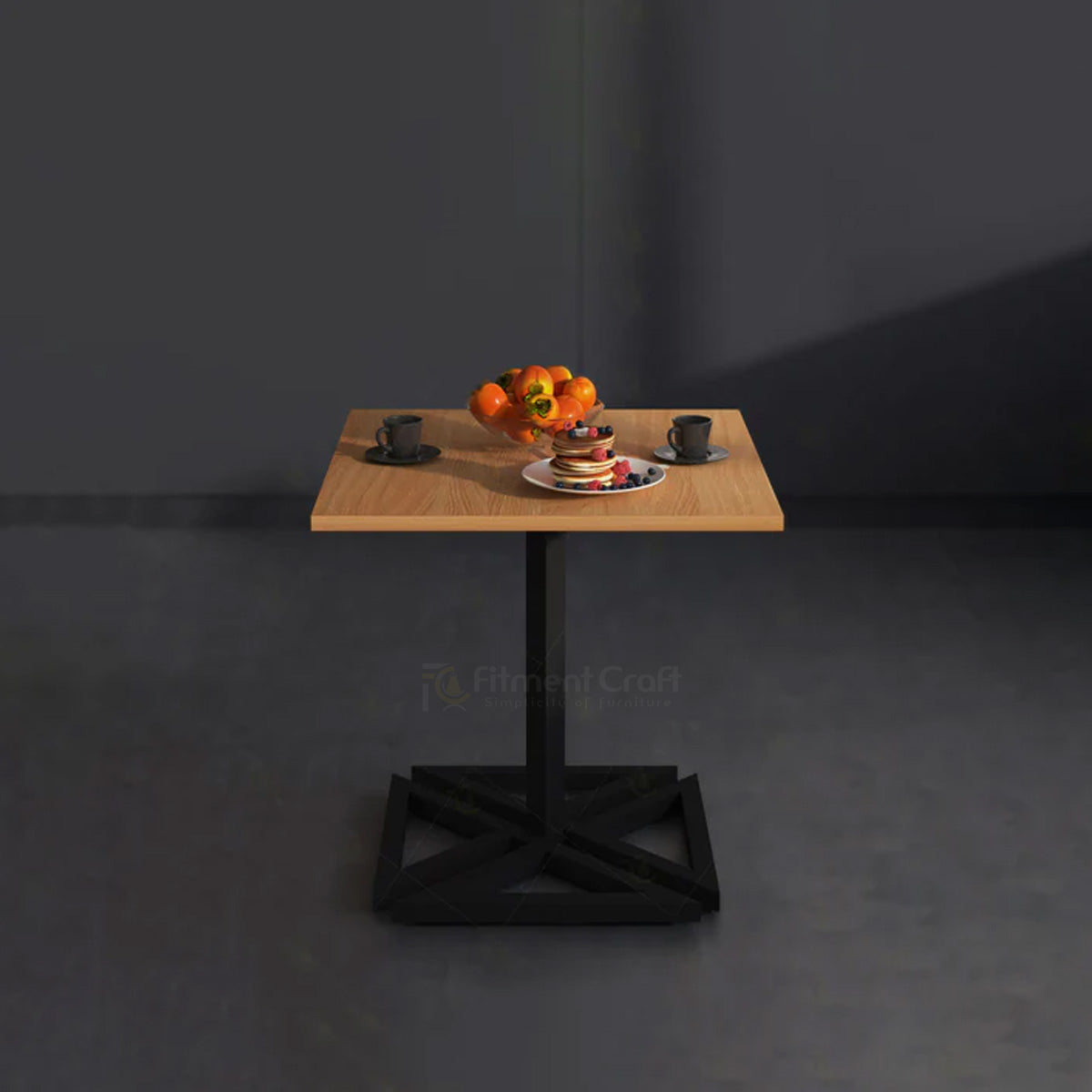 Cubic square table with wood-tone top and black geometric base set for a meal