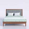 DreamScape bed with grey padded headboard and green bedding, front view