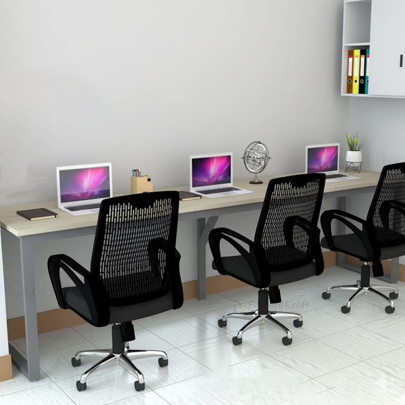 Eclectic workstation with laptops and three black mesh chairs, close angled view