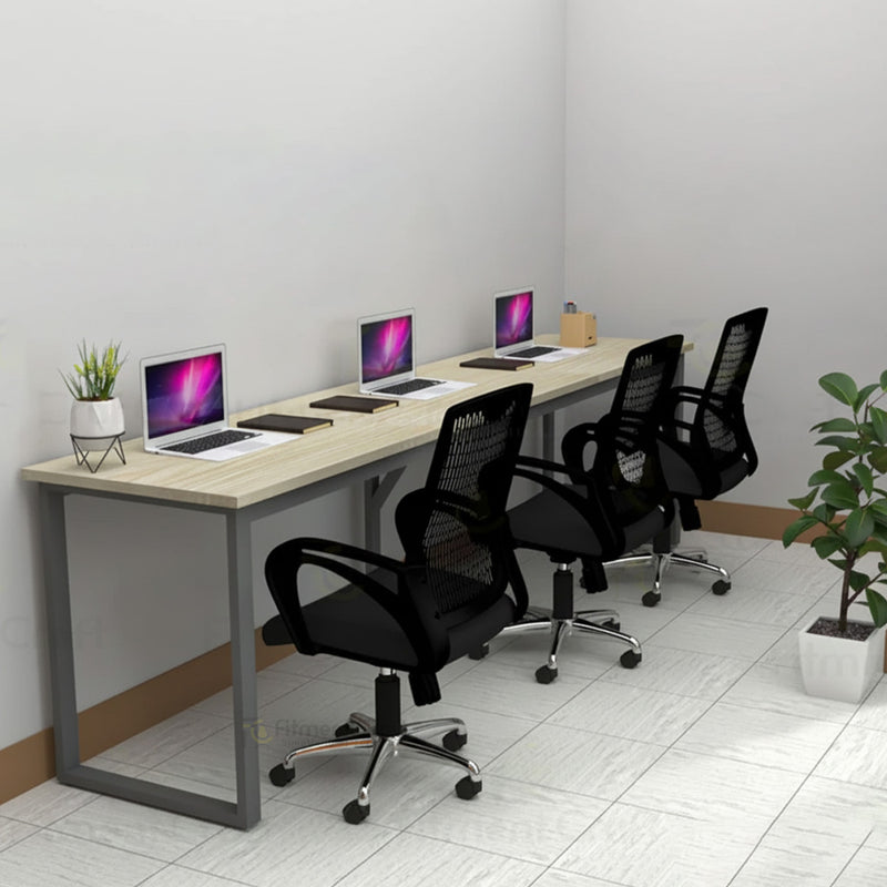 Eclectic three-person workstation with light desktop, laptops and black chairs, angled view