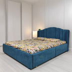Blue Erana bed with tall upholstered headboard and patterned mattress in a bedroom