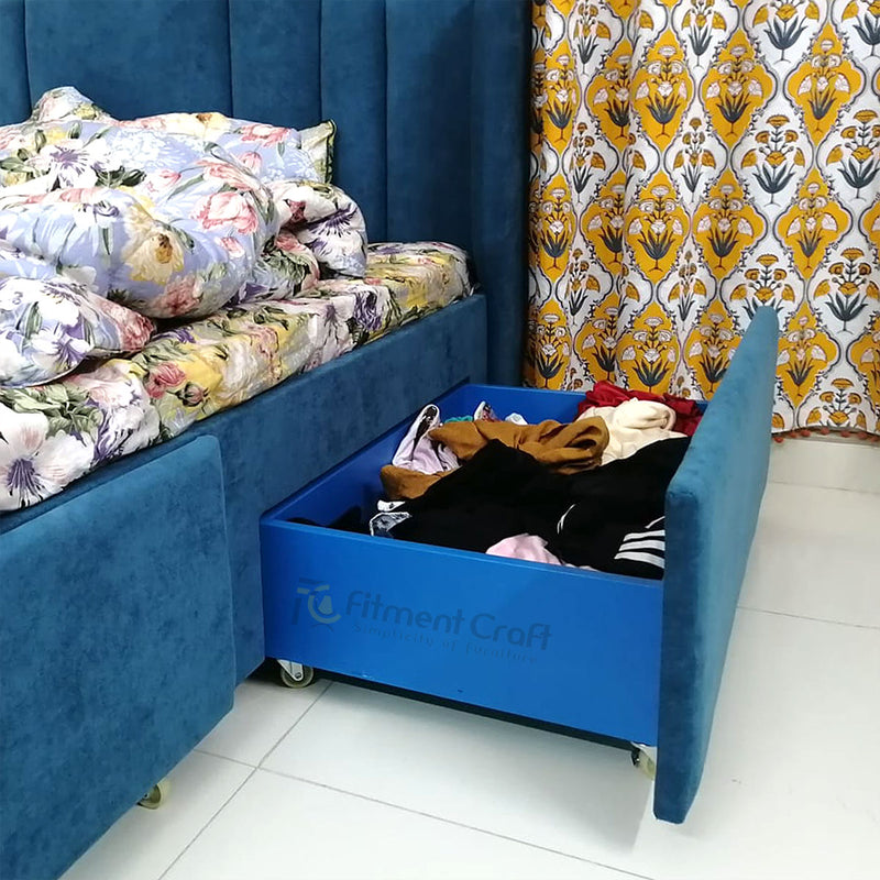 Erana bed with blue under-bed storage drawer pulled open to show clothing