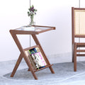 Brown Frostelle side table with crossed legs, tray-style top and angled magazine shelf