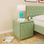 Green Astro bedside cabinet with geometric door pattern beside a bed