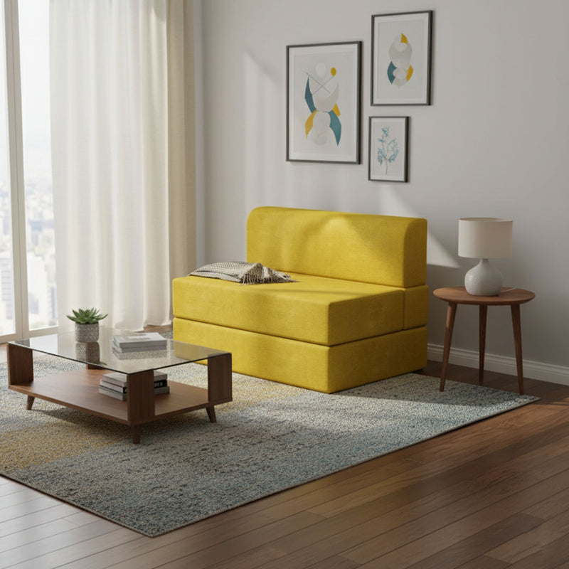 Mustard yellow Lorien sofa bed beside a coffee table in a living room