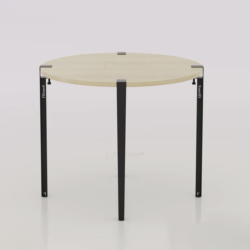 Orba round table with pale wood-tone top and black legs, overhead angled view