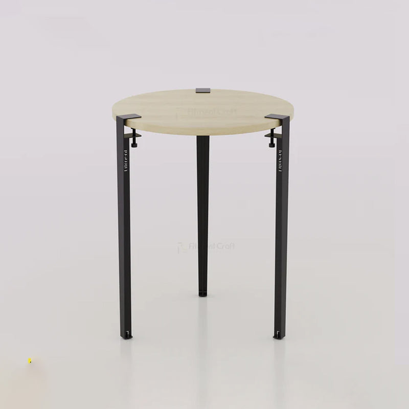 Orba round table with pale wood-tone top and black legs, front view