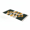 Orva rectangular rug with green, mustard, white and grey geometric pattern and fringed edges
