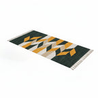 Orva rectangular rug with green, mustard, white and grey geometric pattern and fringed edges