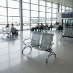 Silver Oryan two-seat waiting chair with perforated seats and curved arms in a terminal