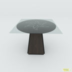 Front view of Prism coffee table with a square glass top, circular floral design and dark tapered pedestal