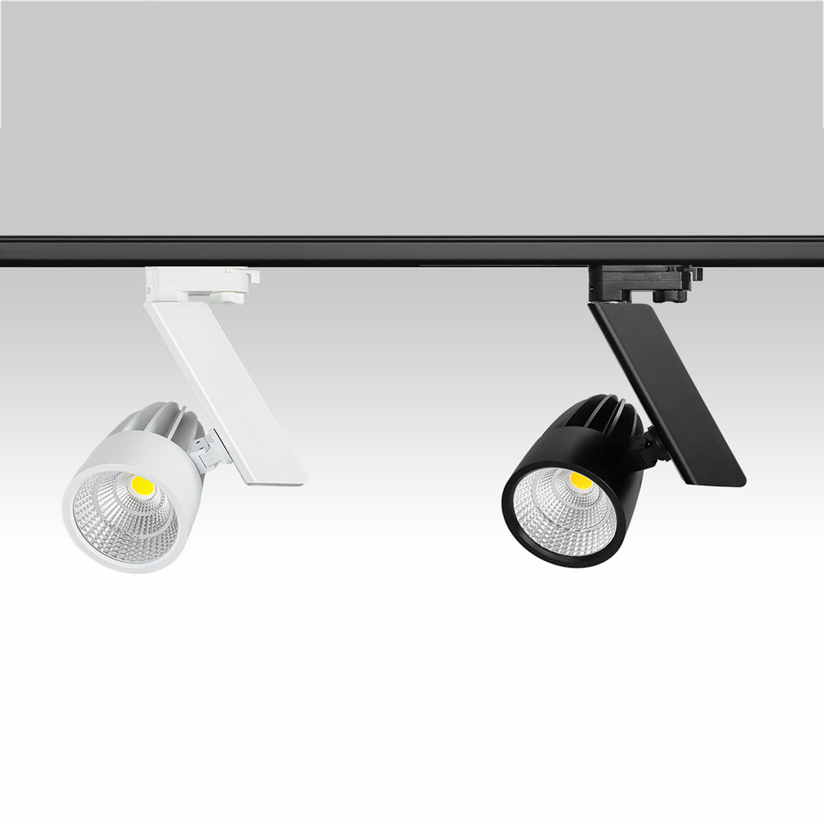 White and black Resly track spotlights mounted on a black lighting rail
