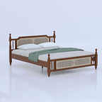 Brown Signature bed with turned posts, pale inset panels and green throw, angled view