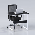 Sleek desk with black top, white frame and black chair, staged with a laptop
