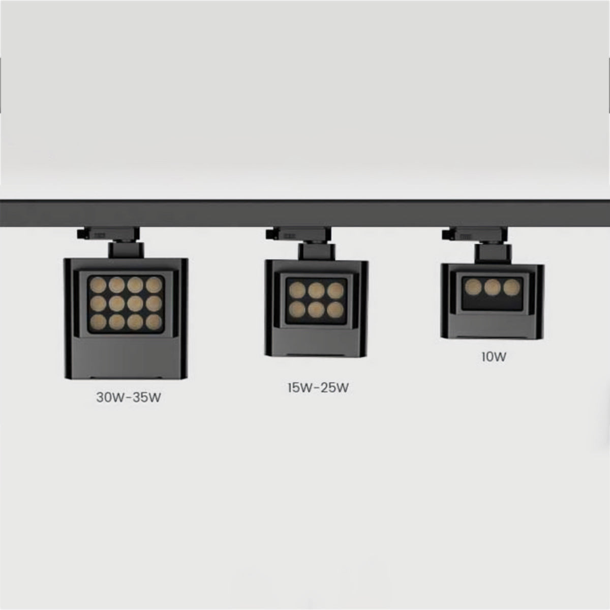 Three black Fenley track lights with different rectangular LED faces and wattage labels