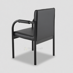 Black Vizio visitor chair with curved arms and padded back, rear angled view