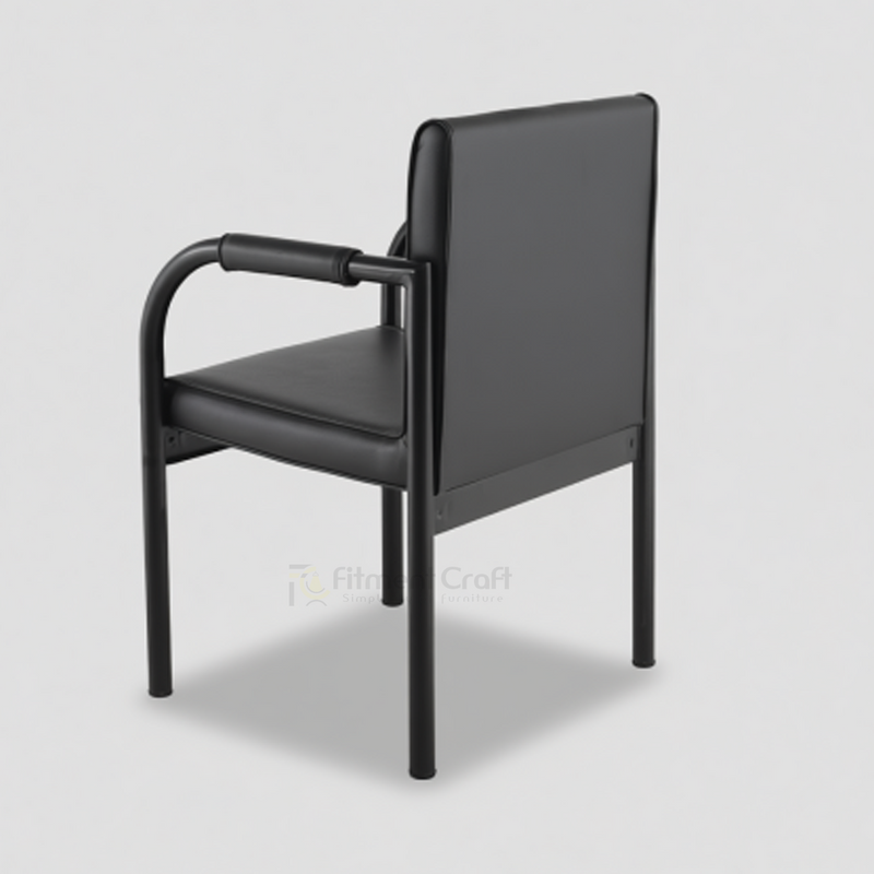 Black Vizio visitor chair with curved arms and padded back, rear angled view