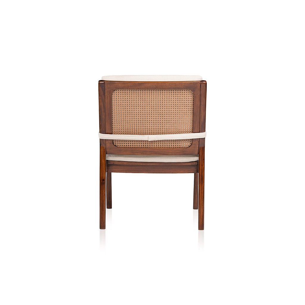 Rear view of the Walden lounge chair showing its woven PVC rattan back panel, wooden frame, and cream cushion strap.
