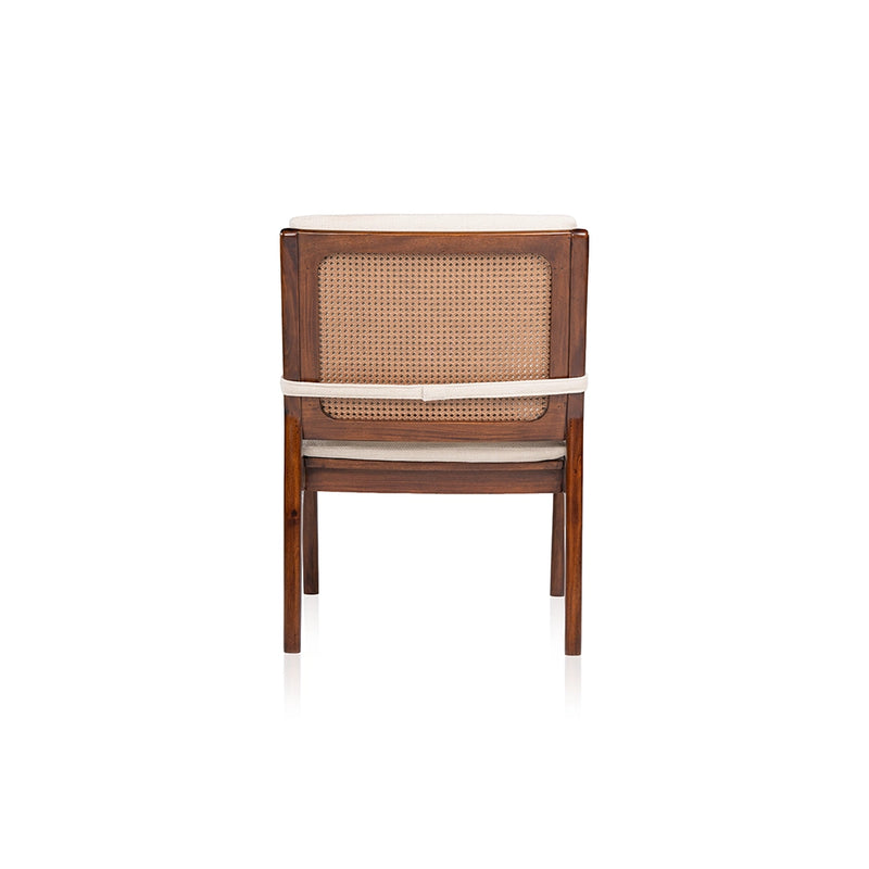 Rear view of the Walden lounge chair showing its woven PVC rattan back panel, wooden frame, and cream cushion strap.